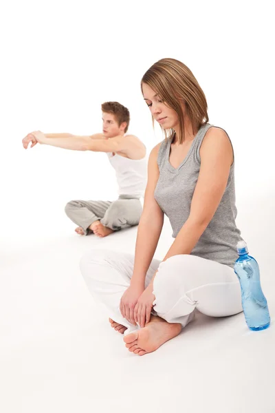 Fitness - Healthy couple stretching after training on white — Stock Photo, Image