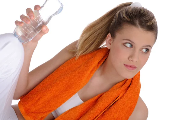Fitness - Young sportive woman with water and towel — Stock Photo, Image