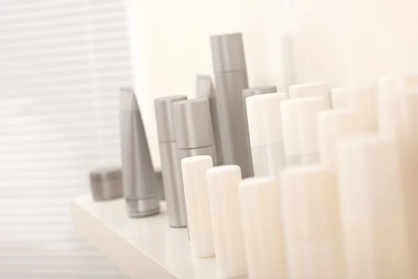 stock image Hair and body care cosmetics white and gray bottles, shallow depth-of-field