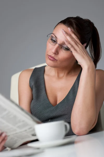 Tankeväckande affärskvinna läsa tidningen på kontor — Stockfoto