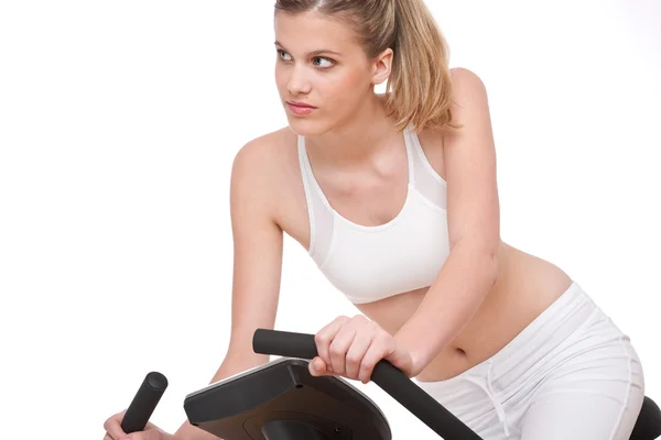 Série de fitness - Mulher jovem com bicicleta de exercício — Fotografia de Stock