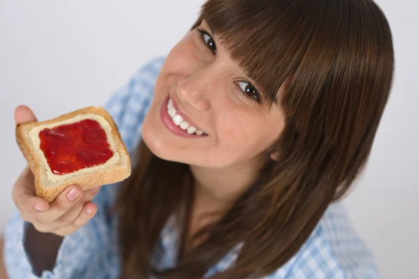 Счастливый подросток в пижаме ест здоровые тосты — стоковое фото