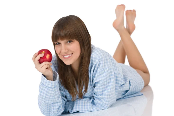 パジャマの白い背景の上の朝食健康リンゴを食べて幸せなティーンエイ ジャー — ストック写真