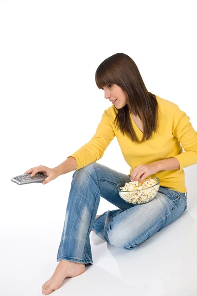Happy Female Teenager Watching Television Holding Remote Control Eating Popcorn — Stock Fotó