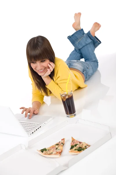 Happy female teenager with laptop and pizza — Stock Photo, Image
