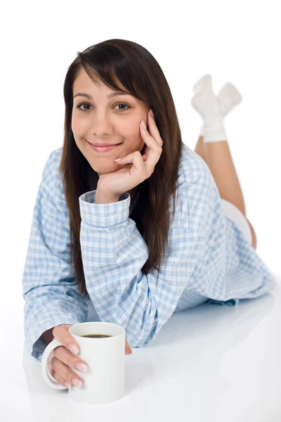 Happy young woman with coffee in pajamas — Stock Photo, Image