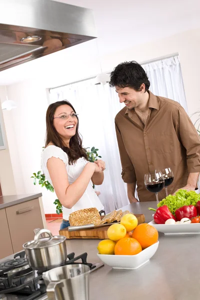 Cooking - happy couple together in modern kitchen — Stock Photo, Image