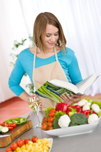 Cozinhar - Mulher lendo livro de receitas na cozinha — Fotografia de Stock