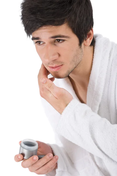 Cuidado Facial Hombre Joven Aplicando Crema Hidratante Sobre Fondo Blanco —  Fotos de Stock