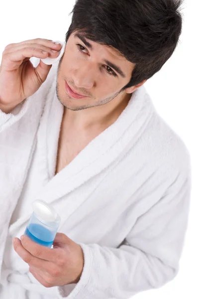 Cuidado Facial Hombre Joven Limpiando Cara Con Loción Sobre Fondo —  Fotos de Stock