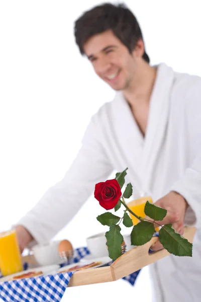 Breakfast - young man holding tray with rose — Stock Photo, Image
