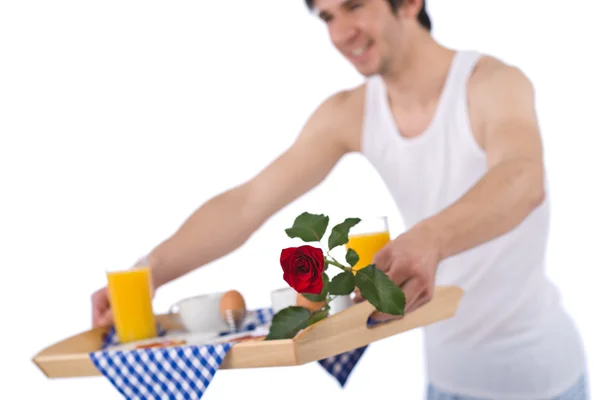 Breakfast - young man holding tray with rose — Stock Photo, Image