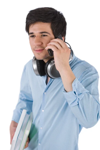 Manlig student ringa med mobiltelefon hålla böcker — Stockfoto