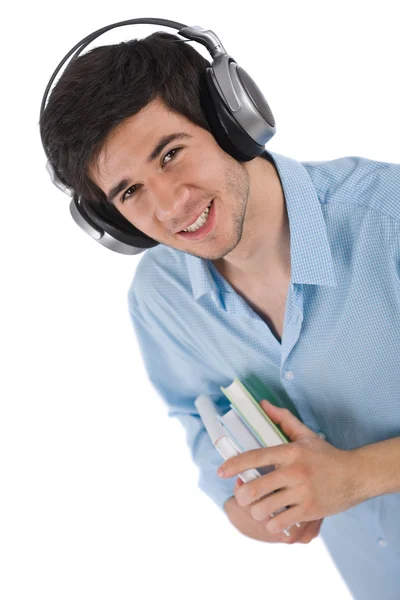 Mannelijke student met koptelefoon houden boeken — Stockfoto