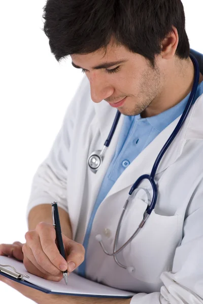 Male student doctor with stethoscope writing — Stock Photo, Image