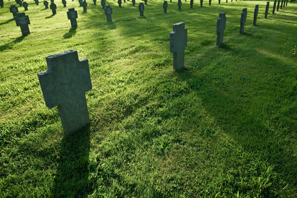 Cemetery with grass during sunset, long shadows