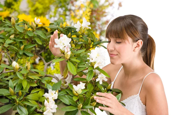 Portrait of woman smelling blossom of Rhododendron flower — Stock Photo, Image