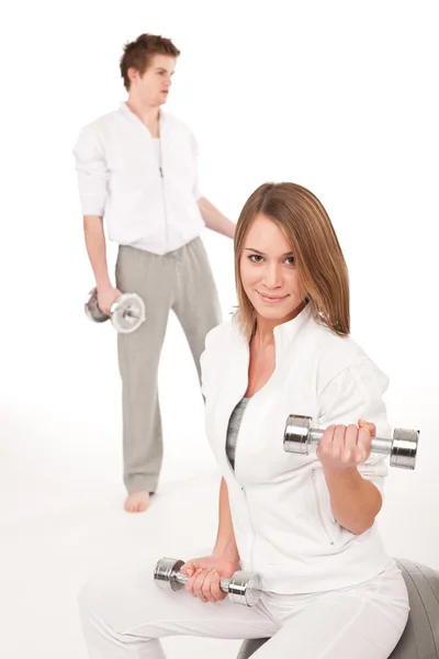 Fitness - Young couple training with weights and ball Royalty Free Stock Photos