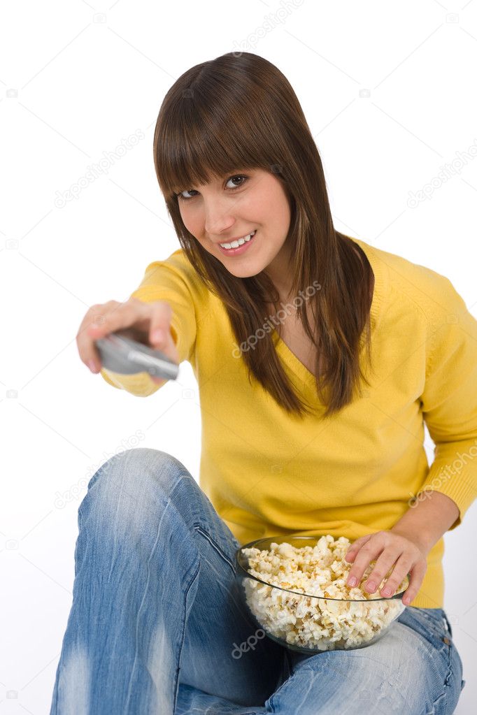 Happy female teenager watching television