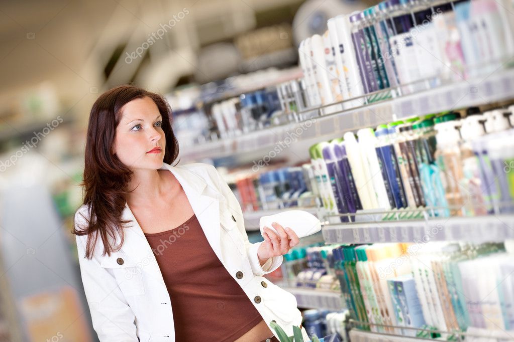 Shopping series - Young woman holding shampoo