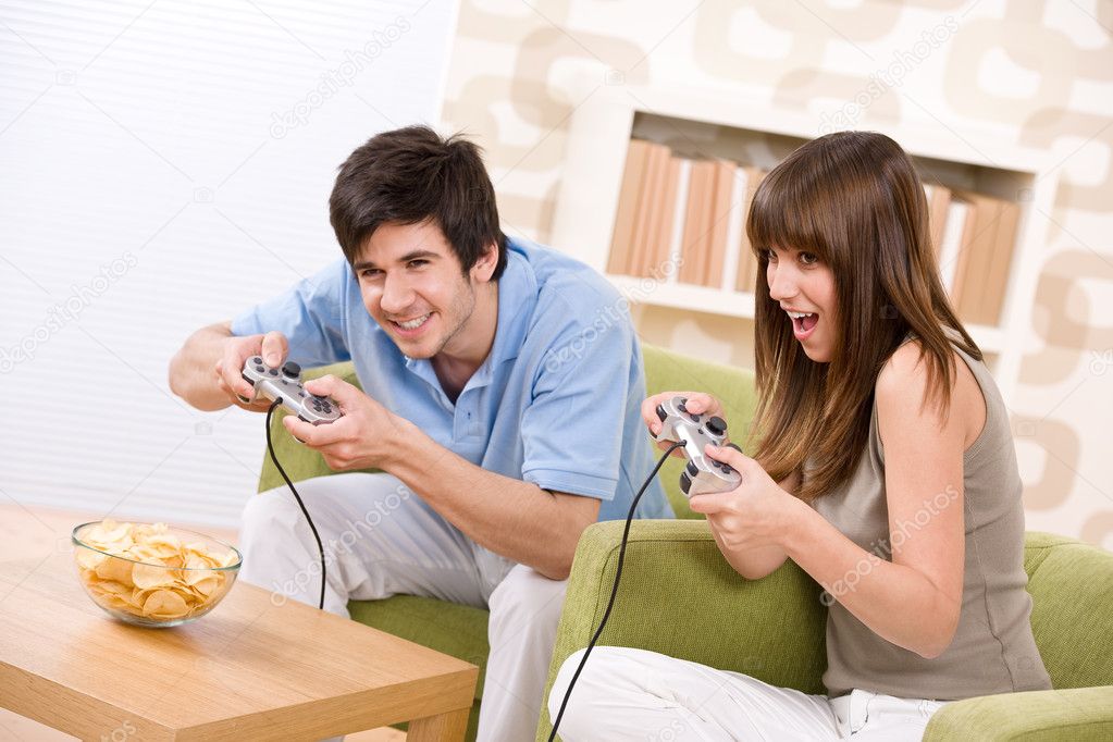 Student - happy teenagers playing video game having fun