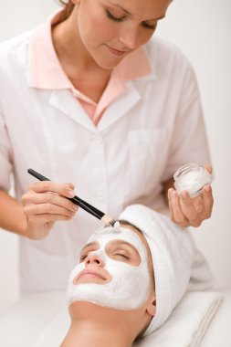 Facial mask - woman at beauty salon clipart