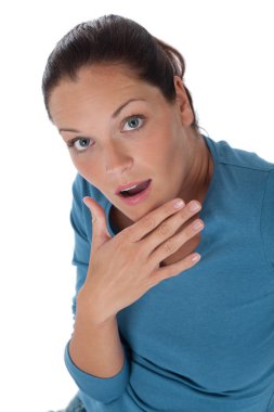 Surprised young woman in turqouise vest on white background