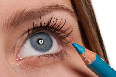 Blue eye, woman applying turqouise make-up pencil clipart