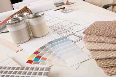 Office of interior designer with paint and color swatch on the desk clipart