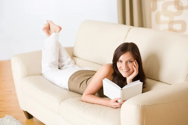 Junge Glückliche Frau Liest Buch Auf Sofa Wohnzimmer — Stockfoto