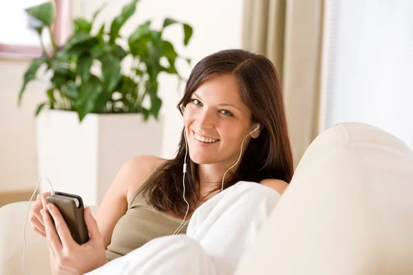 Woman Holding Music Player Listening Earbuds Lying Sofa Home — Stock Photo, Image