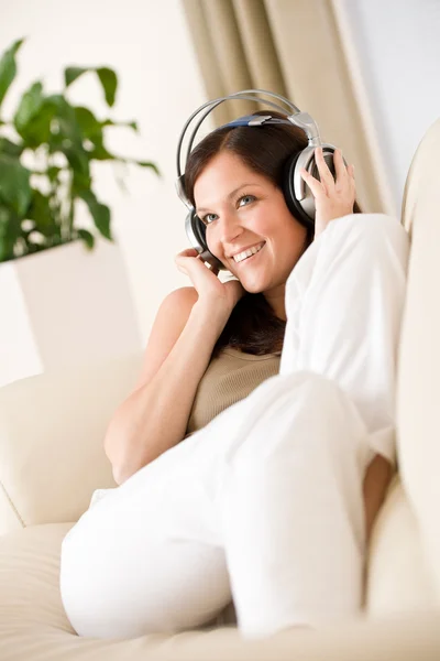 Усміхнена жінка з навушниками слухати музику — стокове фото