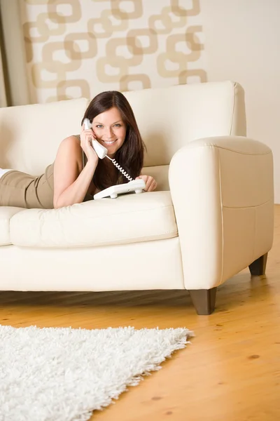 On the phone: young woman calling in lounge — Stock Photo, Image
