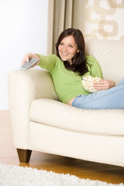 Woman pointing with television remote control — Stock Photo, Image