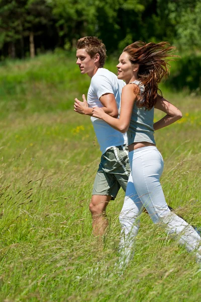 Young couple jogging outdoors in spring nature — Stock Photo, Image