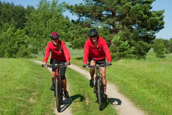 Jeune couple avec vélo de montagne au printemps nature — Photo