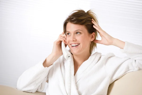 Mutlu bir kadın, beyaz bornoz ile telefon — Stok fotoğraf