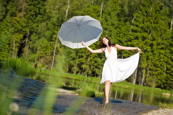 Happy romantic woman with parasol in sunlight — Stock Photo, Image