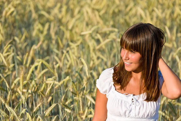 Mujer joven en el campo de maíz disfrutar de la puesta del sol —  Fotos de Stock