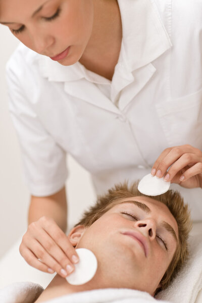 Male cosmetics - cleaning face treatment at luxury spa