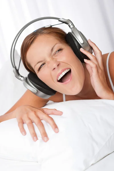 Young woman in white with headphones — Stock Photo, Image