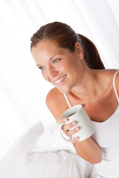 Beautiful young woman holding cup of coffee — Stock Photo, Image