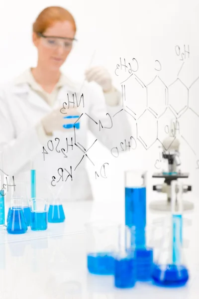 女科学家在实验室用显微镜和化学公式 — 图库照片