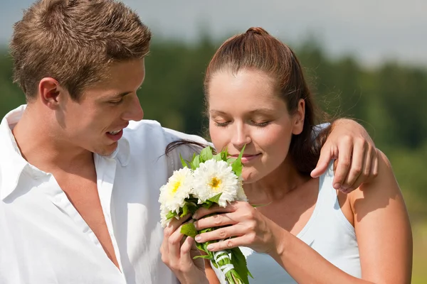 Casal romântico com flor na primavera — Fotografia de Stock