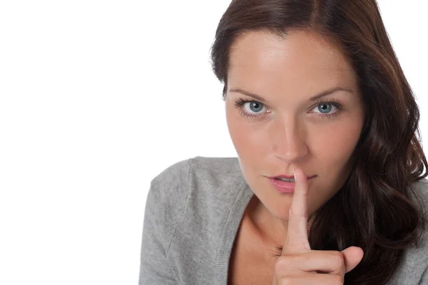 Brown hair woman with with finger on lips — Stock Photo, Image
