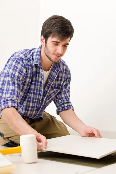 Home improvement - handyman laying tile — Stock Photo, Image