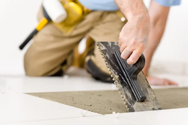 Home improvement, renovation - handyman laying tile — Stock Photo, Image