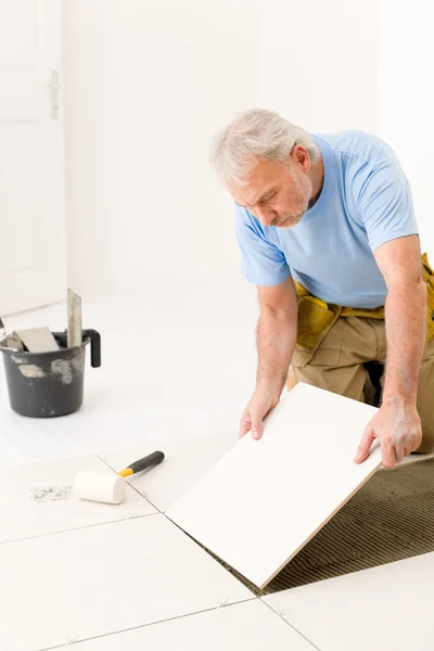 Home improvement - handyman laying ceramic tile — Stock Photo, Image