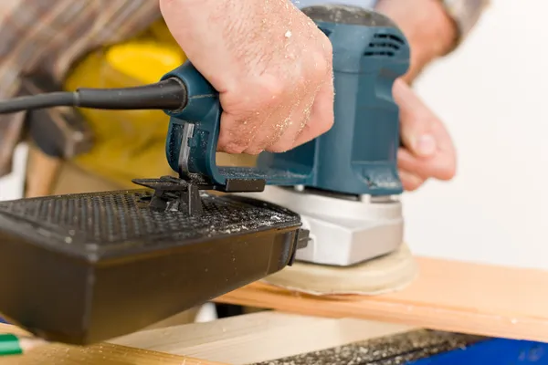 Home improvement - handyman sanding wooden floor — Stock Photo, Image