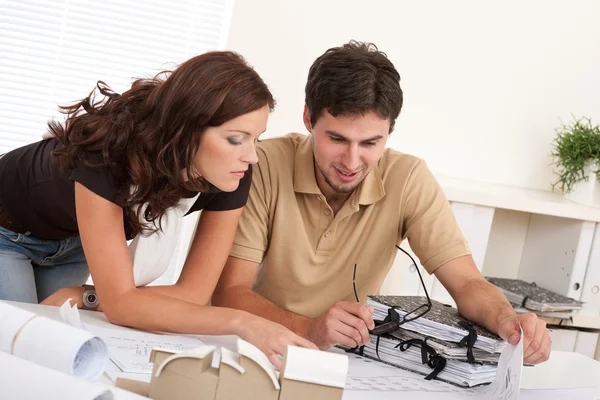 Young man and woman working at architect office — Stock Photo, Image